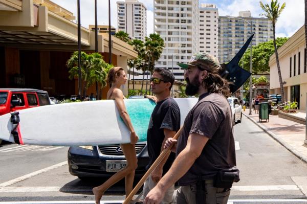 Andrew Roberts (right), director of the Hawaii Firearms Coalition, holds a halberd while walking down Kalakaua Avenue in Waikiki.